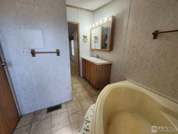 a bathroom with a bathtub and mirror