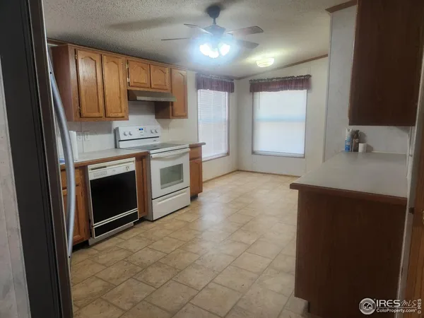 a kitchen with stainless steel appliances a stove a sink and a refrigerator
