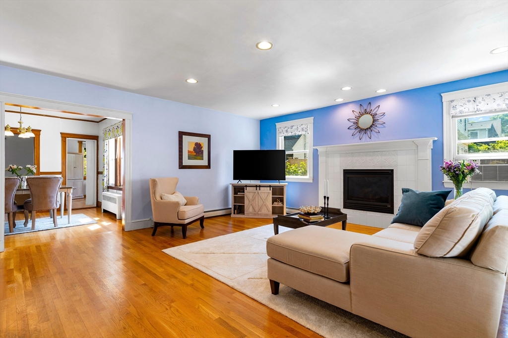 102 Gleason Road Lexington, MA 02420 - Photo 12 of 37 a living room with furniture a flat screen tv and a fireplace
