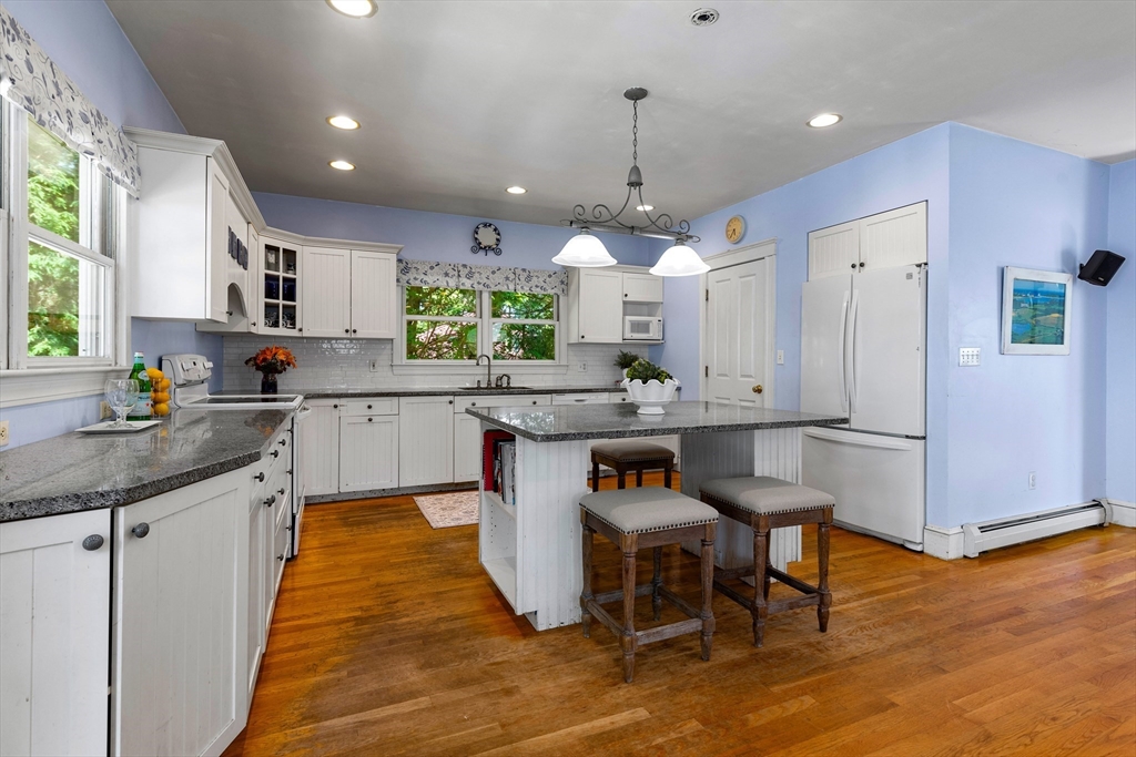 102 Gleason Road Lexington, MA 02420 - Photo 15 of 37 a kitchen with stainless steel appliances kitchen island granite countertop a sink and a refrigerator