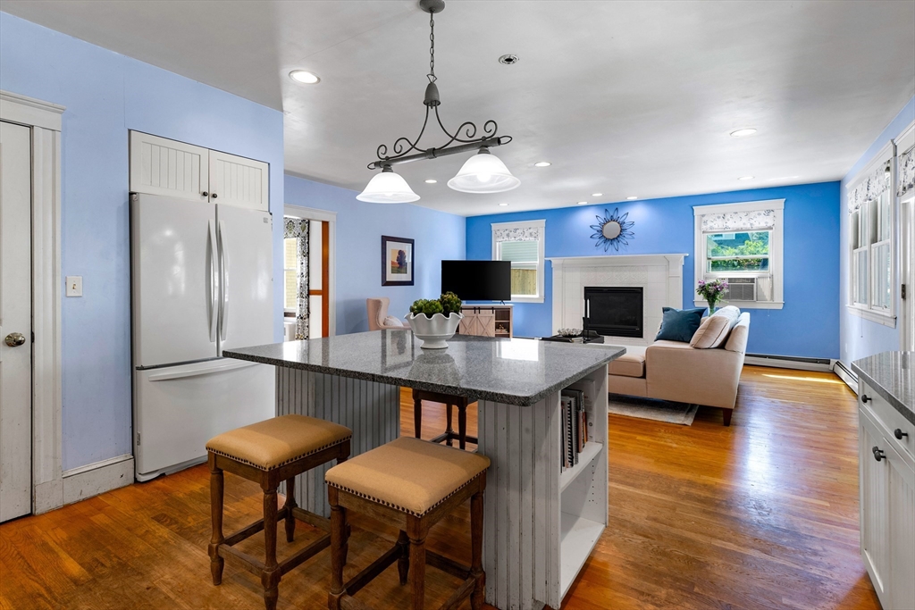 102 Gleason Road Lexington, MA 02420 - Photo 18 of 37 a living room with stainless steel appliances granite countertop furniture a fireplace a rug and a window