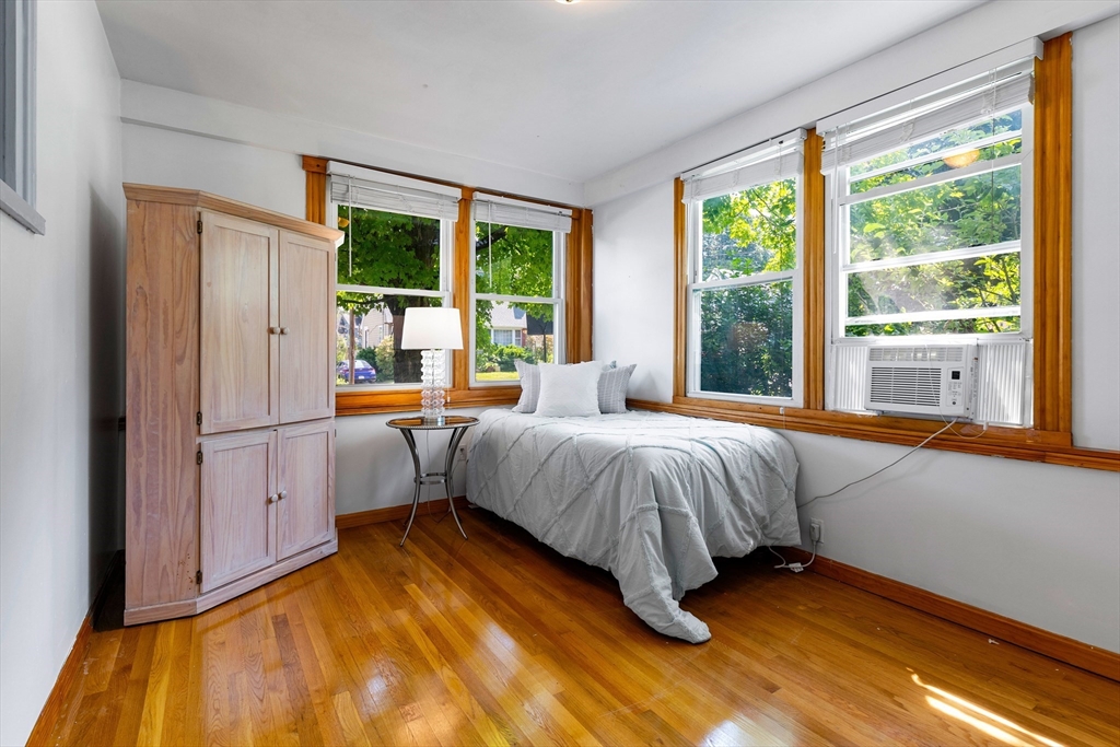 102 Gleason Road Lexington, MA 02420 - Photo 19 of 37 a bedroom with a bed and a large window