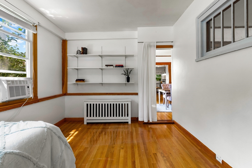 102 Gleason Road Lexington, MA 02420 - Photo 20 of 37 a bedroom with a bed and wooden floor