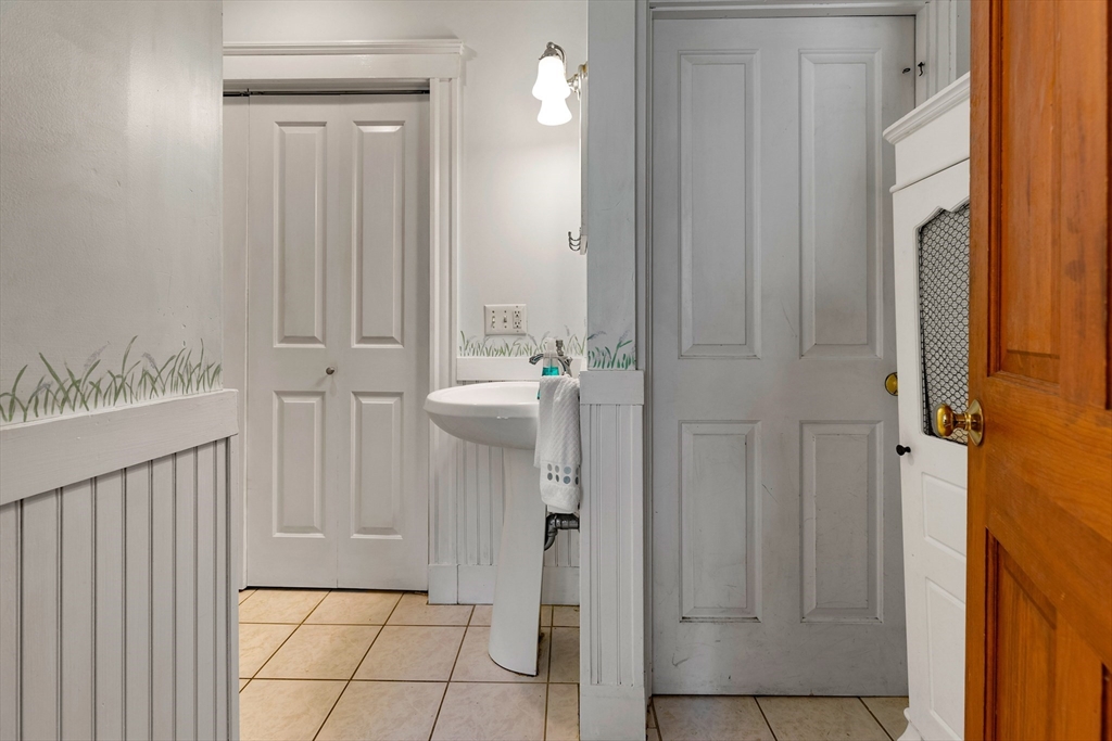 102 Gleason Road Lexington, MA 02420 - Photo 21 of 37 a view of a hallway with wooden floor and cabinet