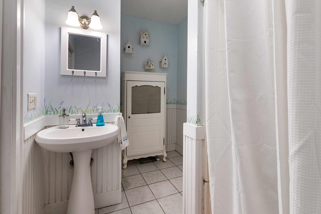102 Gleason Road Lexington, MA 02420 - Photo 22 of 37 a bathroom with a sink and a mirror