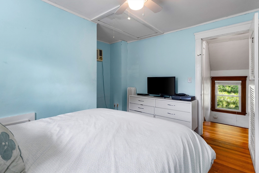 102 Gleason Road Lexington, MA 02420 - Photo 29 of 37 a bedroom with a bed and a flat screen tv