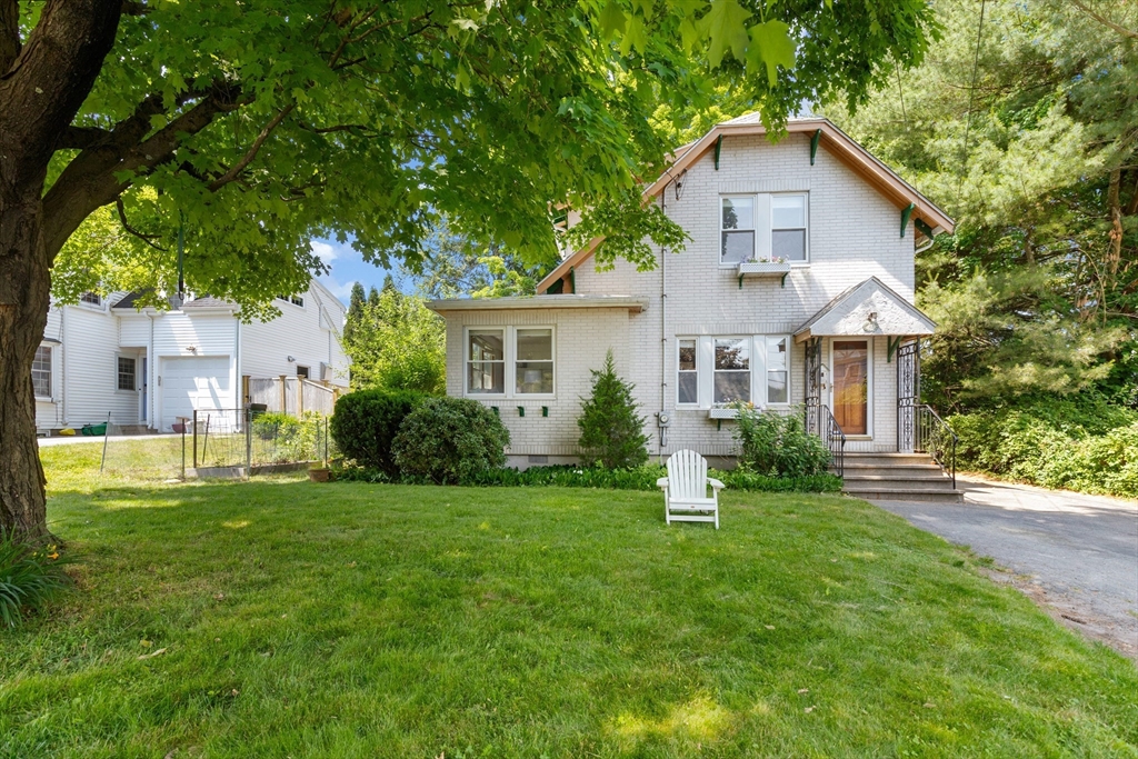 102 Gleason Road Lexington, MA 02420 - Photo 3 of 37 a front view of a house with a yard and trees