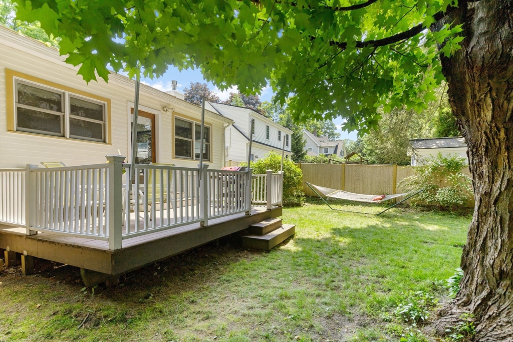 102 Gleason Road Lexington, MA 02420 - Photo 31 of 37 a view of a house with a yard deck and a small yard