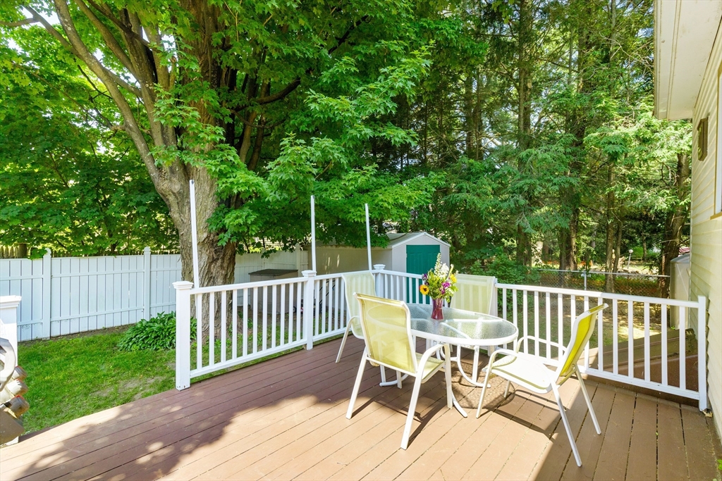 102 Gleason Road Lexington, MA 02420 - Photo 33 of 37 a view of a deck with a table and chairs