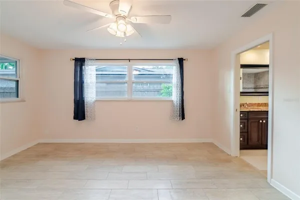 an empty room with windows and closet