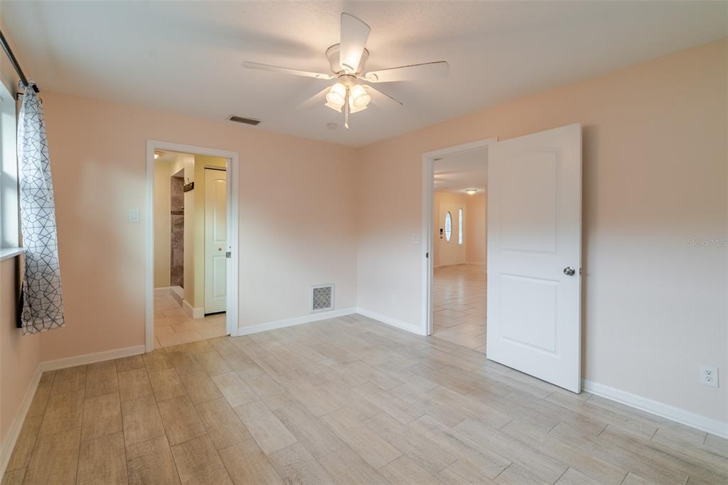 8918 134th Street North Seminole, FL 33776 - Photo 12 of 37 wooden floor in an empty room with a window