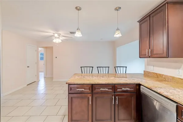 a kitchen with a sink a refrigerator and cabinets