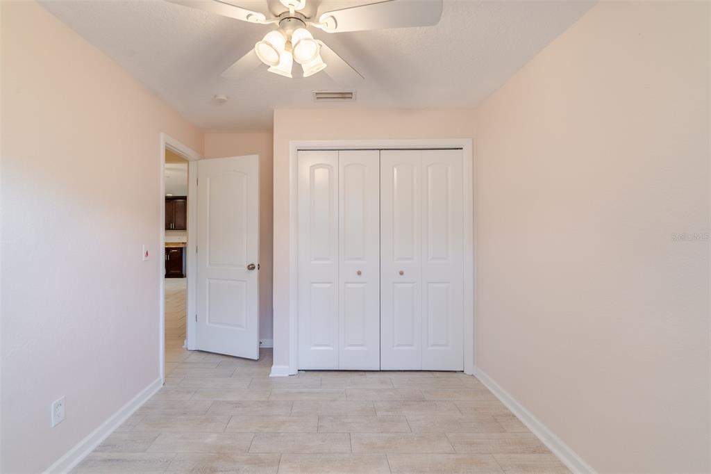 8918 134th Street North Seminole, FL 33776 - Photo 23 of 37 an empty room with a ceiling fan and a window