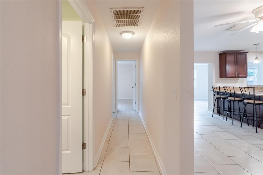 8918 134th Street North Seminole, FL 33776 - Photo 24 of 37 a view of a hallway with dining area and chandelier