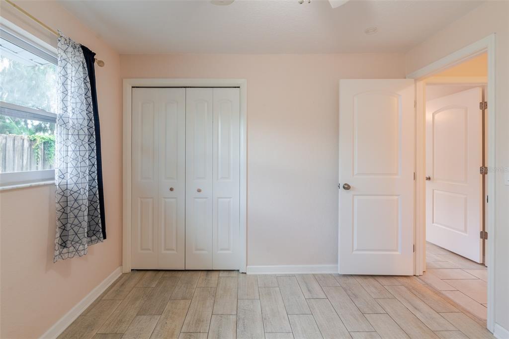 8918 134th Street North Seminole, FL 33776 - Photo 27 of 37 a view of an empty room with wooden floor and a window