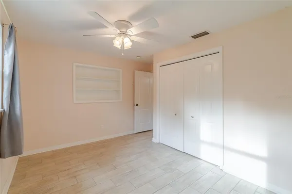 a view of an empty room with a fan