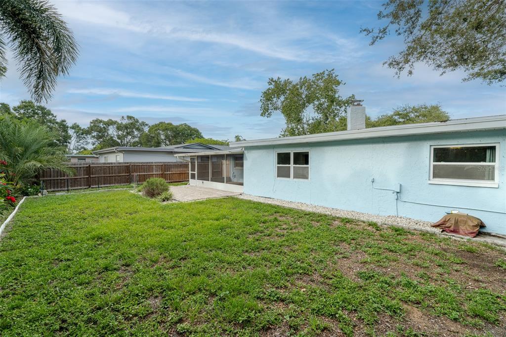 8918 134th Street North Seminole, FL 33776 - Photo 36 of 37 a backyard of a house with table and chairs