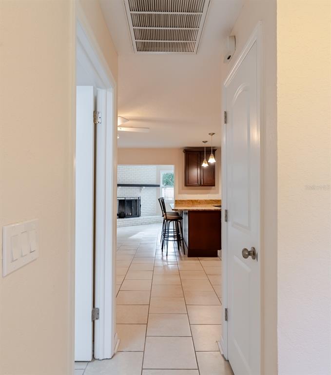 8918 134th Street North Seminole, FL 33776 - Photo 4 of 37 a kitchen with stainless steel appliances kitchen island granite countertop a refrigerator and a stove