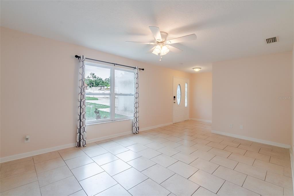 8918 134th Street North Seminole, FL 33776 - Photo 8 of 37 a view of an empty room with a window