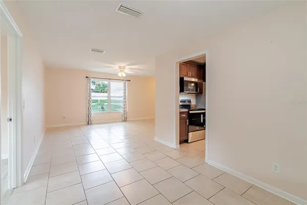a view of a kitchen with a sink and a refrigerator