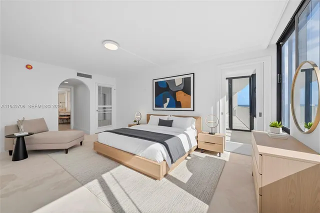 a spacious bedroom with a bed a couch and dresser