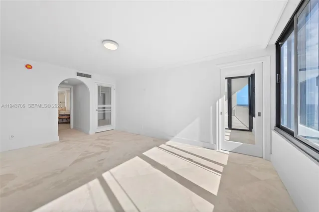 a view of a hallway with a white walls and chandelier