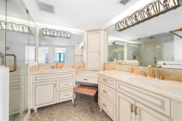a spacious bathroom with a shower a sink and a mirror