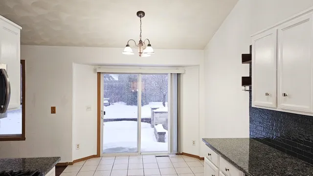 a view of a kitchen with a sink and dishwasher with wooden floor