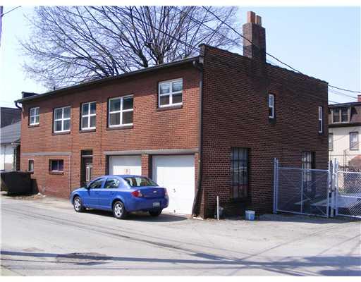 Exterior Front. Rear building  with four apartments  and  a two car garage.