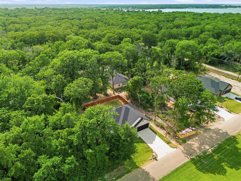 429 Waterboard Road Trinidad, TX 75163 - Photo 24 of 25 New construction home featuring a dark shingled roof, light-colored driveway, and attached garage
