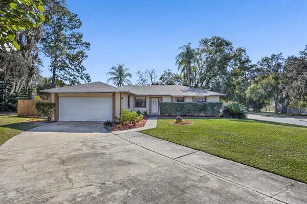 a front view of a house with a yard and a garage