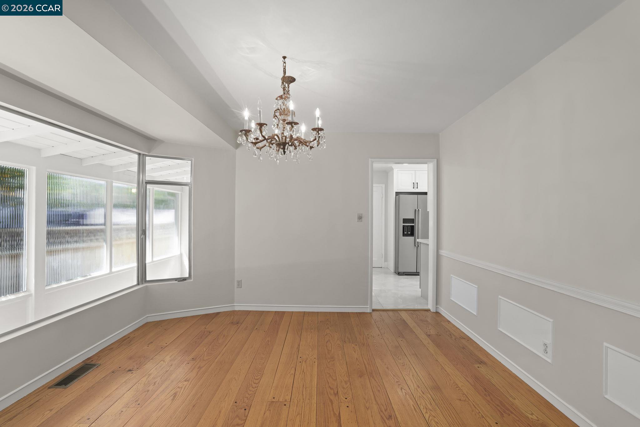 1051 San Rafael Street San Leandro, CA 94577 - Photo 7 of 26 a view of an empty room with wooden floor and a window