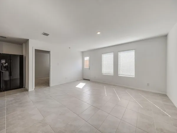 a kitchen with a refrigerator a sink a stove and cabinets