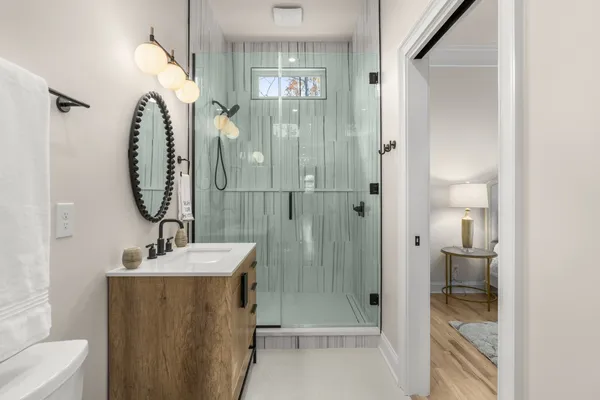 a bathroom with a sink a toilet and shower