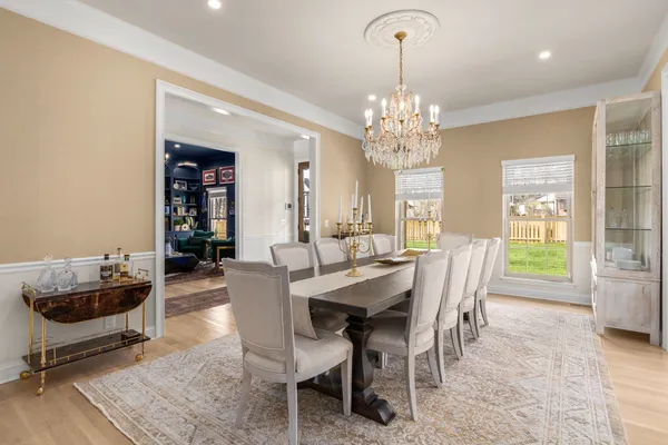 a view of a dining room with furniture and chandelier