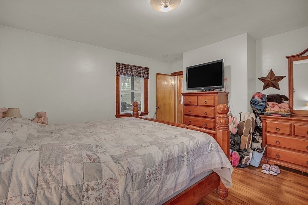 138 Cottage Street Athol, MA 01331 - Photo 15 of 42 a bedroom with a bed and flat screen tv