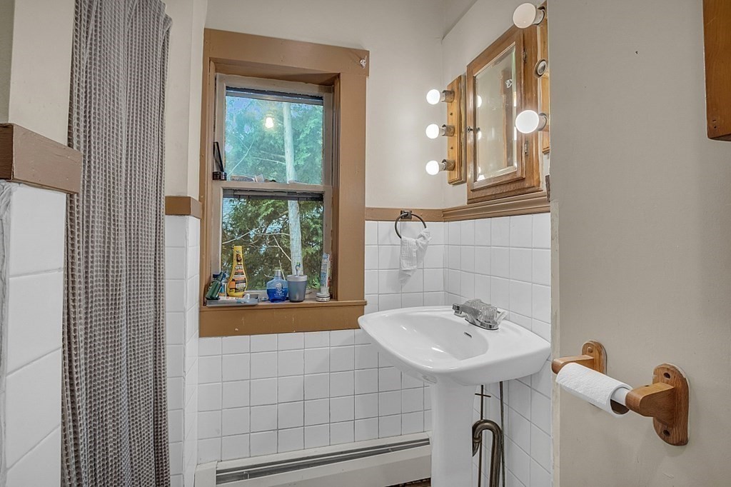 138 Cottage Street Athol, MA 01331 - Photo 24 of 42 a bathroom with a sink a mirror and a shower