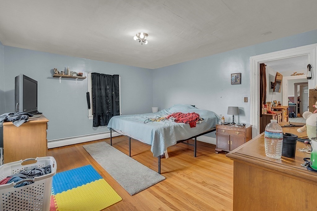 138 Cottage Street Athol, MA 01331 - Photo 25 of 42 a bedroom with furniture and a wooden floor