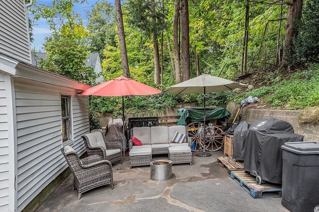 138 Cottage Street Athol, MA 01331 - Photo 39 of 42 a patio with a table and chairs under an umbrella
