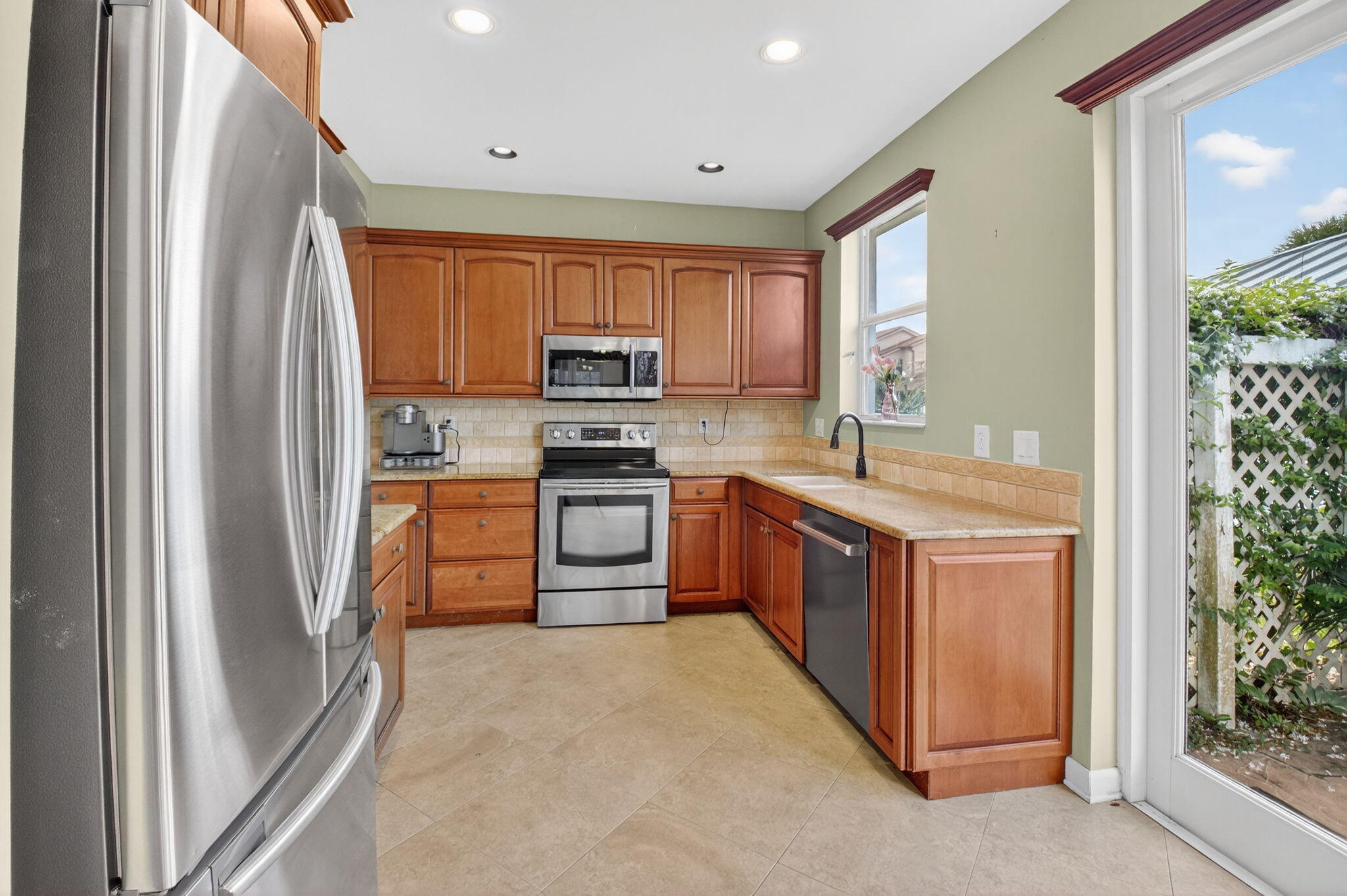 4101 Northwest 2nd Lane Delray Beach, FL 33445 - Photo 13 of 47 a large kitchen with stainless steel appliances granite countertop a stove a sink and a refrigerator