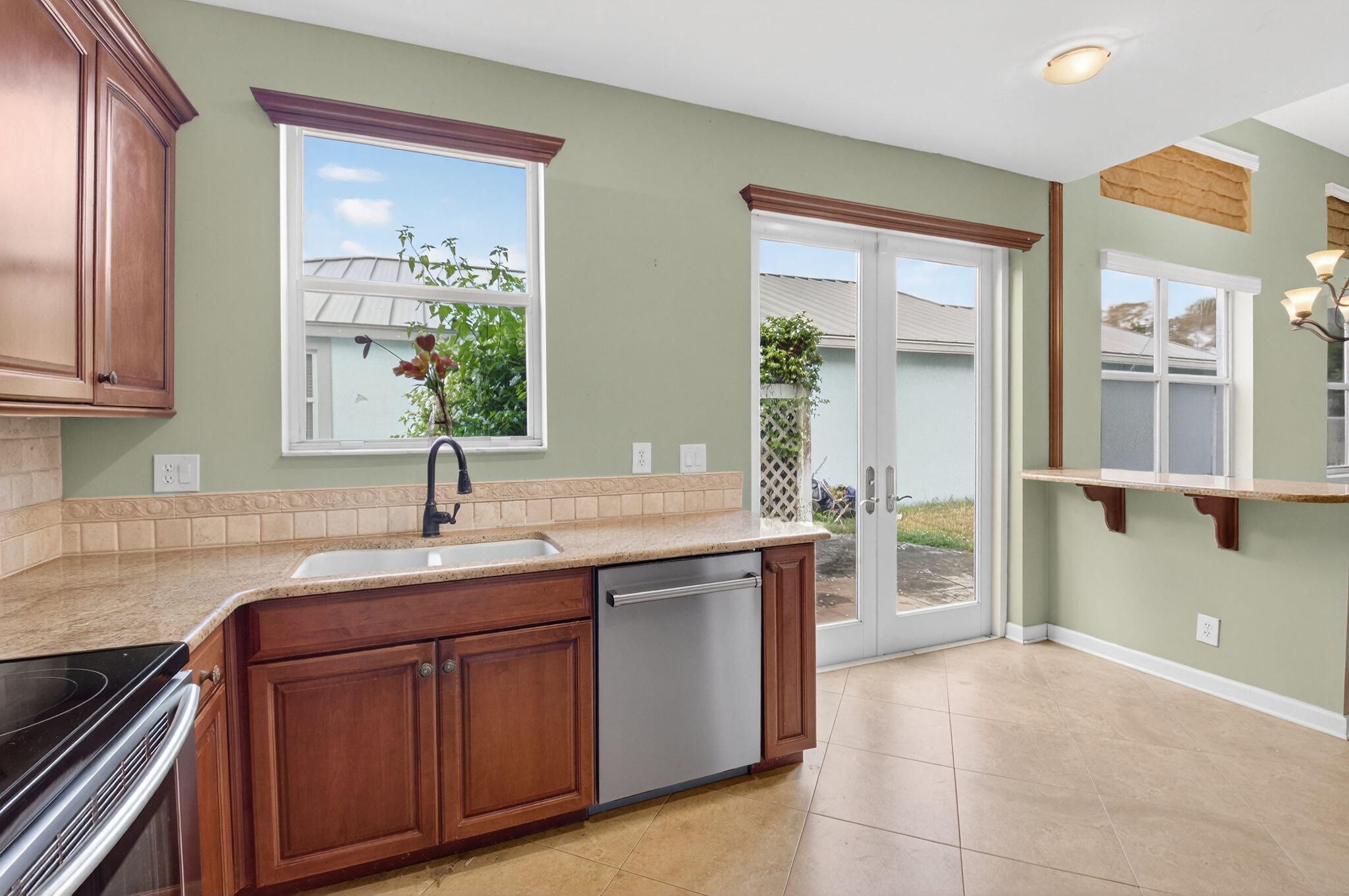 4101 Northwest 2nd Lane Delray Beach, FL 33445 - Photo 14 of 47 a kitchen with kitchen island granite countertop a sink and cabinets