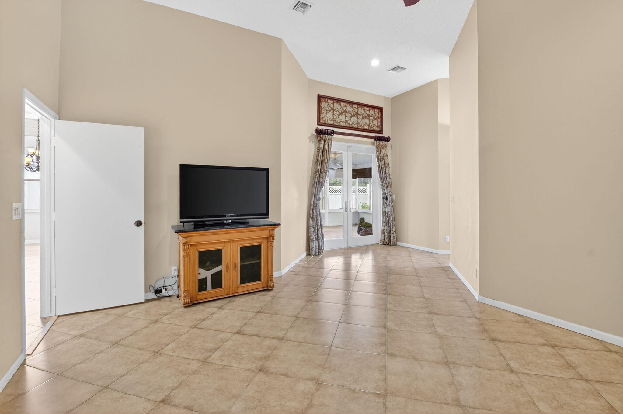 4101 Northwest 2nd Lane Delray Beach, FL 33445 - Photo 18 of 47 a living room with a flat screen tv and kitchen view