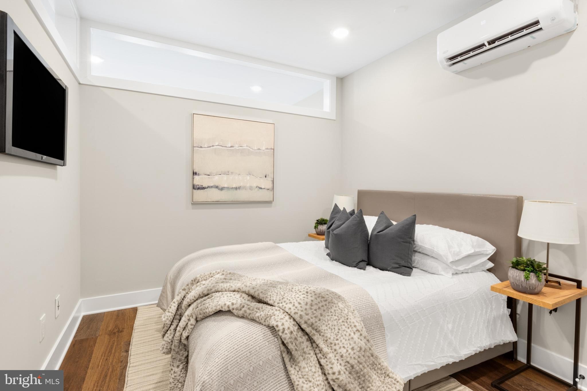 1924 North Front Street, Unit 206 Philadelphia, PA 19122 - Photo 13 of 30 a bedroom with a bed and a tv