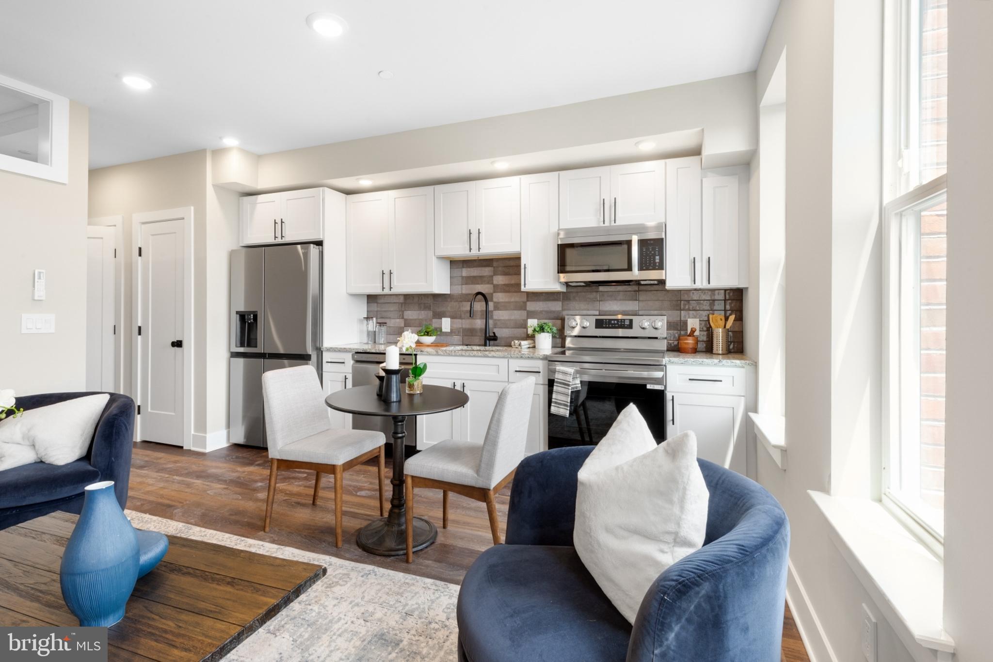1924 North Front Street, Unit 206 Philadelphia, PA 19122 - Photo 2 of 30 a living room with stainless steel appliances furniture and a kitchen view