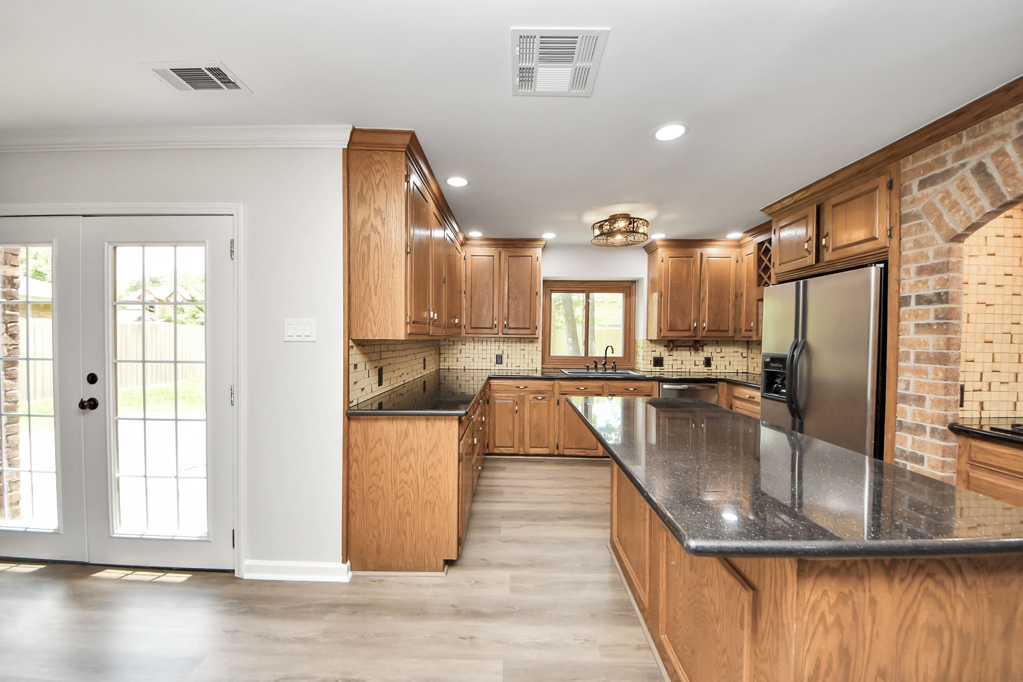 3923 Cypress Lake Drive Spring, TX 77388 - Photo 11 of 48 a kitchen with kitchen island a counter top space a sink stainless steel appliances and cabinets