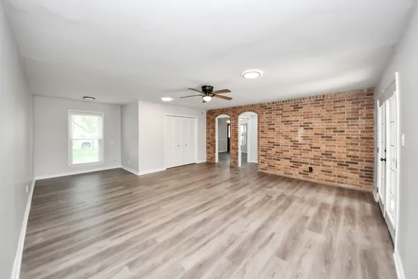 wooden floor in an empty room with a window