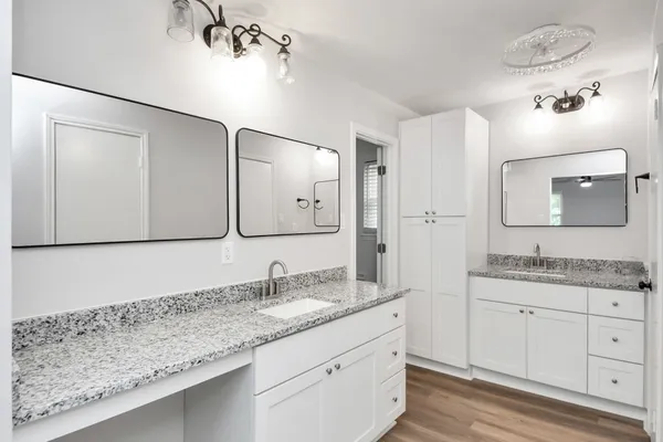 a bathroom with a granite countertop sink mirror and double