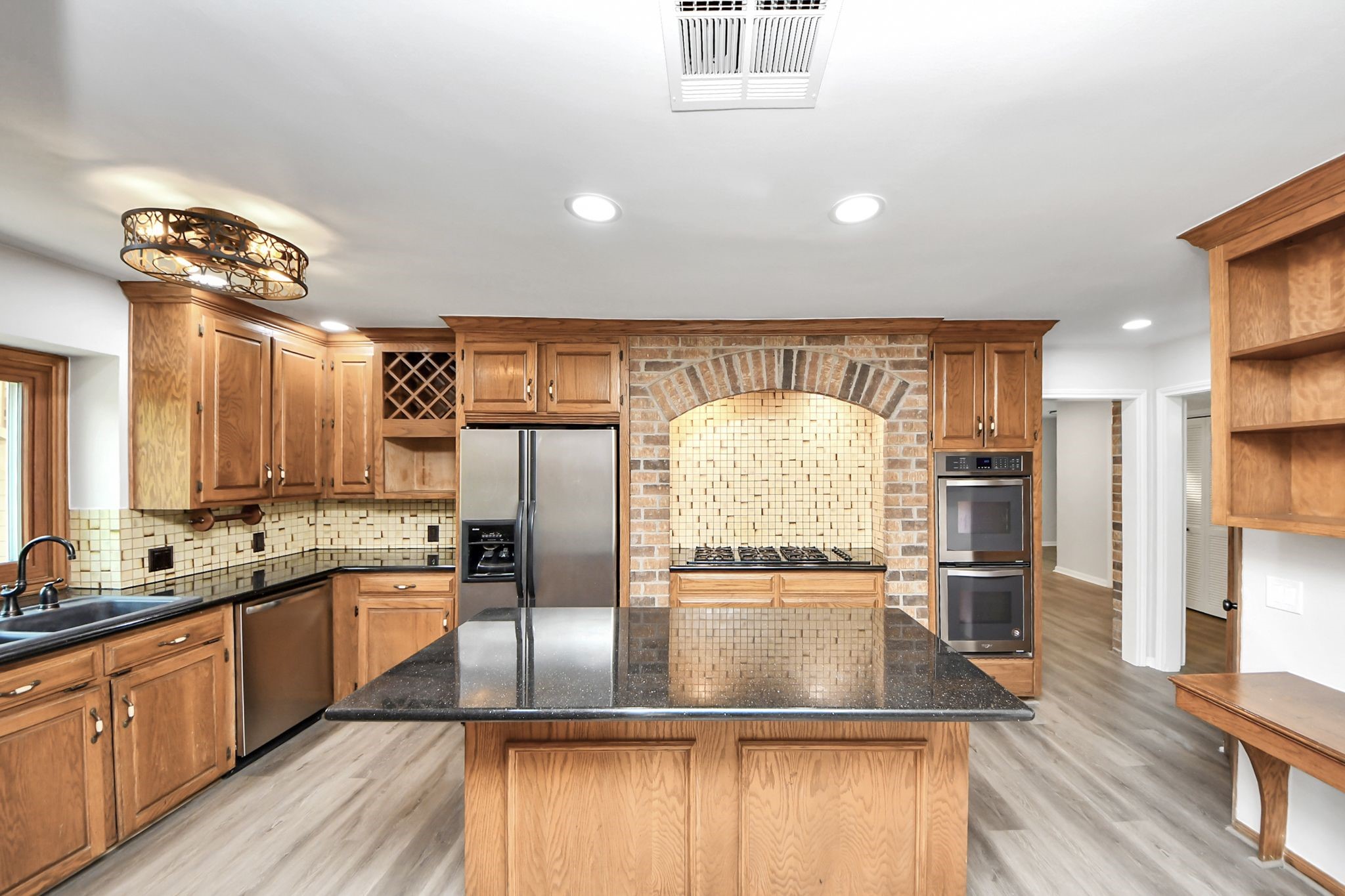 3923 Cypress Lake Drive Spring, TX 77388 - Photo 5 of 48 a view of a kitchen with kitchen island a large counter top space a sink stainless steel appliances and cabinets