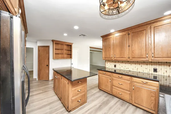 a kitchen with granite countertop a sink and a stove