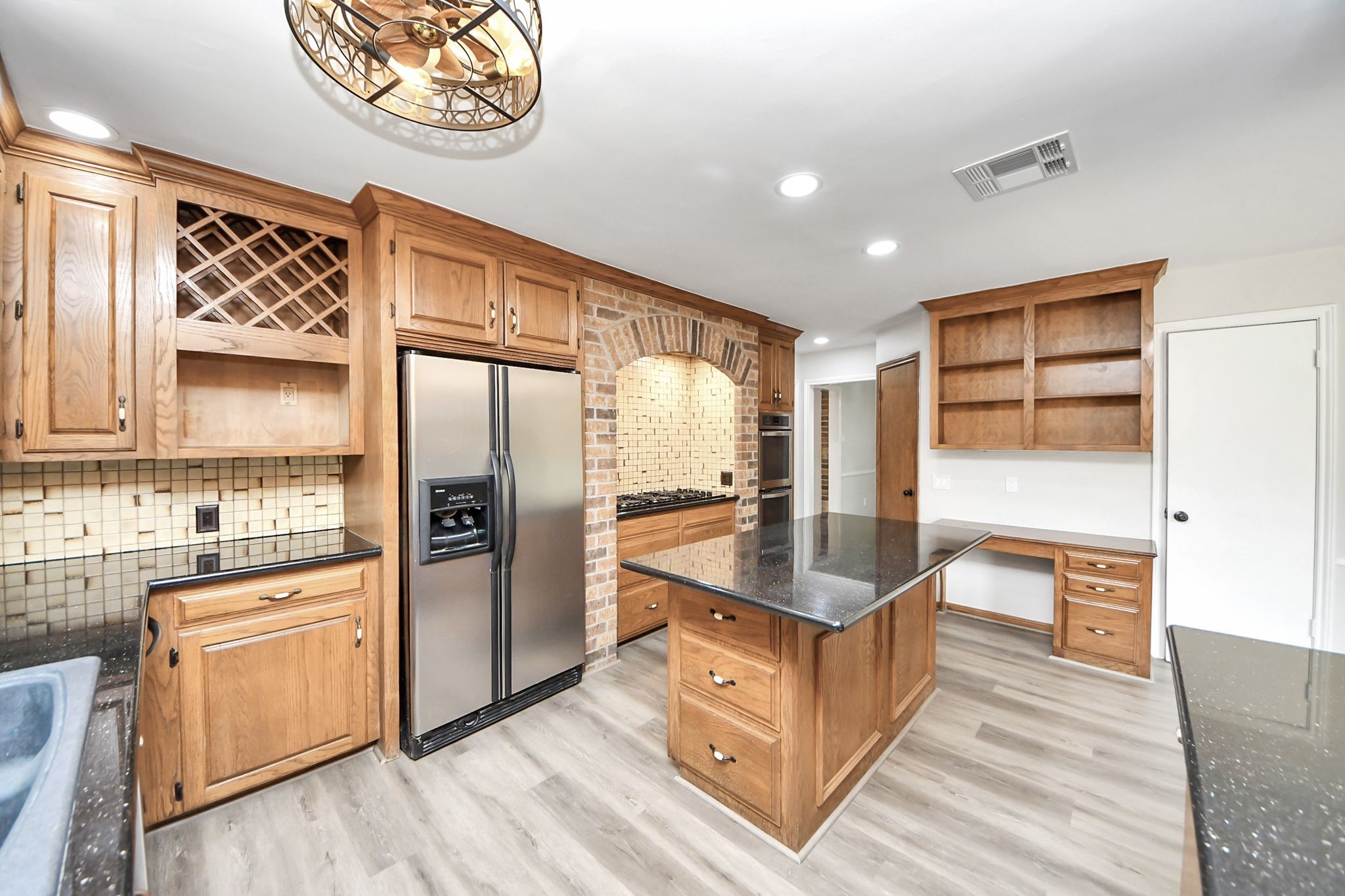 3923 Cypress Lake Drive Spring, TX 77388 - Photo 6 of 48 a kitchen with stainless steel appliances granite countertop a refrigerator a stove and a wooden floors